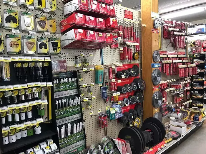 A well-stocked hardware aisle at Great Lakes Rona featuring TASK brand saw blades, hole saws, and drill bit accessories on a pegboard display.